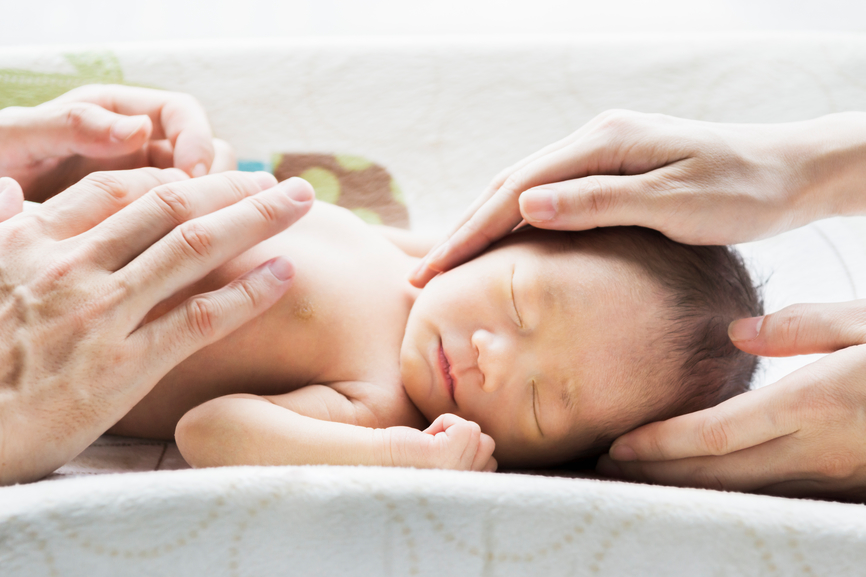 A10-day old Japanese newborn baby girl, massaged by both parents