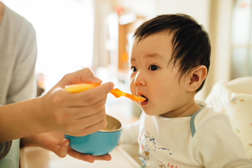 Chinese Young Mother Feeding Her Littler Baby Boy