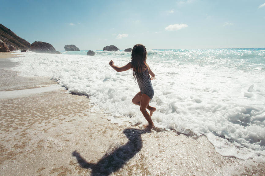 Playful Girl Playing With Waves.