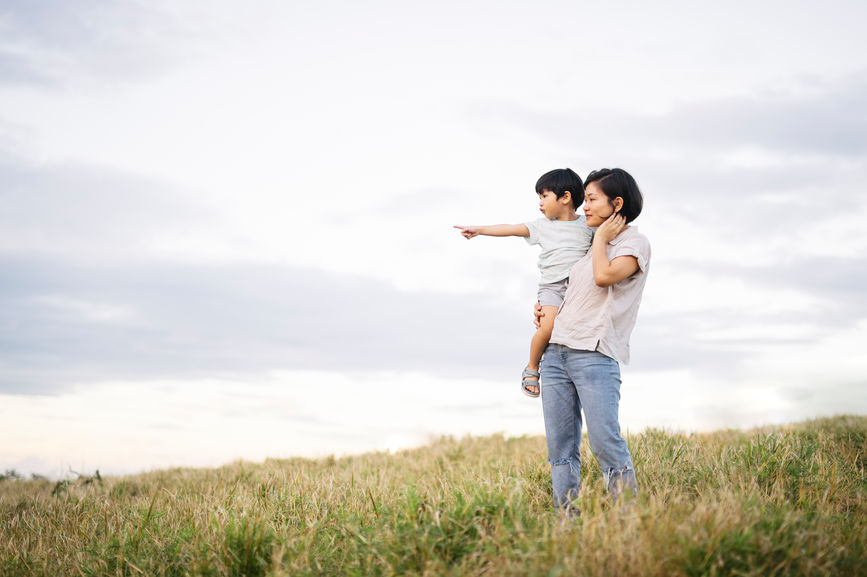 Mother And Son Together At Grass Field