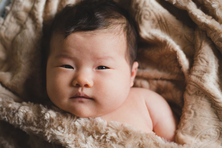 Cute Newborn Baby Looking At Camera