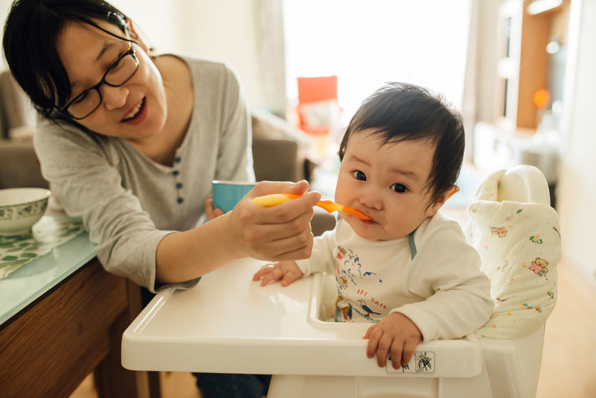 Chinese Young Mother Feeding Her Littler Baby Boy