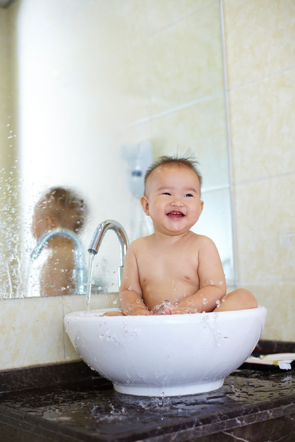 Lovely Baby Girl Sitting In The Basin