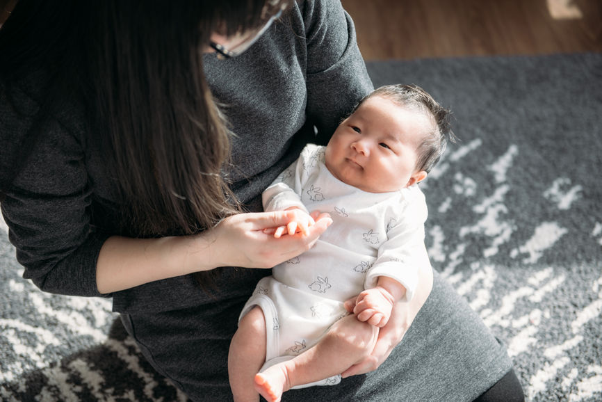 Young Mother And Her New Born Baby At Home